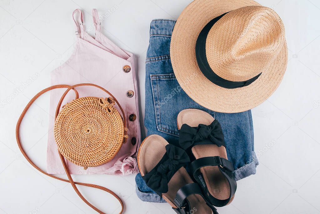 Female fashion outfit - short, pastel top, hat, bag, sandals. Summer holiday clothes. Top view flat lay