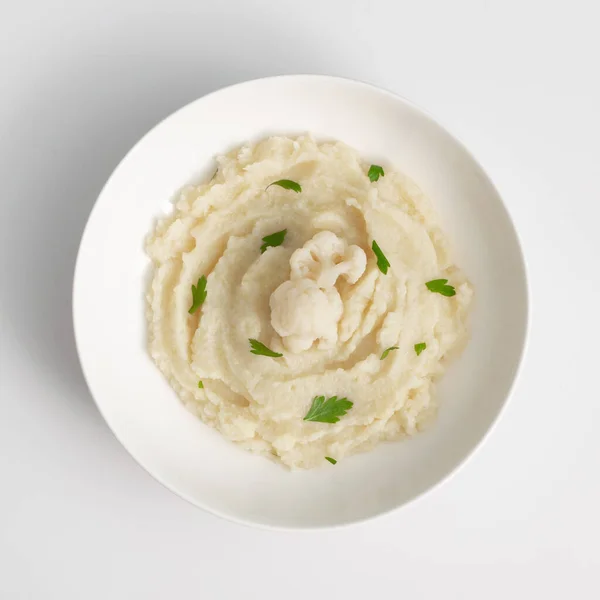Homemade cauliflower puree in white plate closeup, healthy diet vegetable food. Irish colcannon with mashed cabbage, potato and greens on light background top view — Stock Image Homemade Cauliflower Puree White Plate Closeup Healthy Diet Vegetable Food Stock Picture