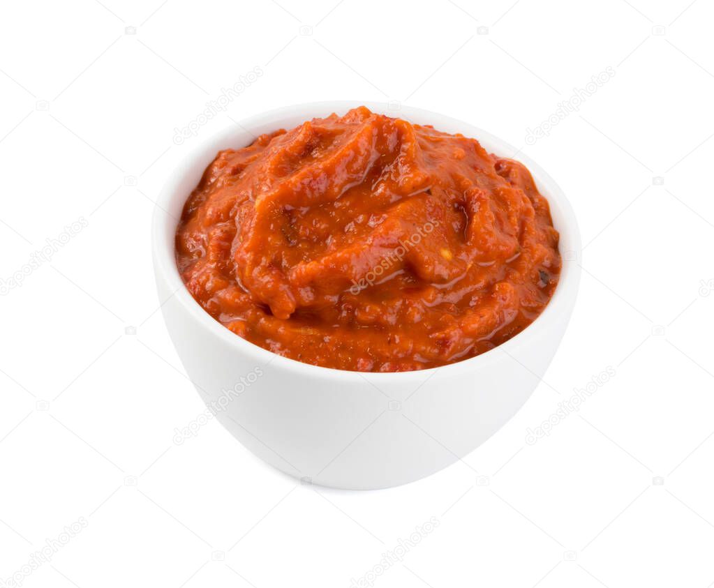 Ajvar or pindjur orange vegetable spread made from bell peppers, eggplants and oil. Marinara sauce, salsa, chutney or lutenica in white bowl isolated