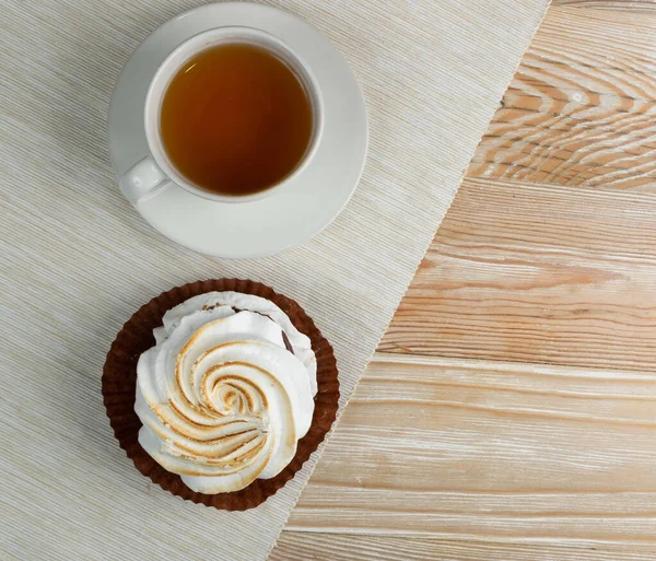 Big white meringue cookie mockup top view. Traditional homemade whisk merengues on wood background with copy space, baked whisking cream mock up or beze cooking recipe template