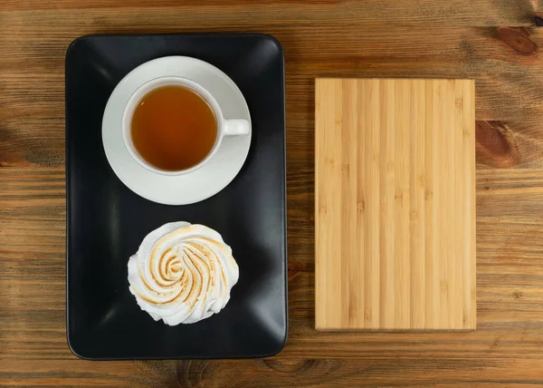 Big white meringue cookie mockup top view. Traditional homemade whisk merengues on wood background with copy space, baked whisking cream mock up or beze cooking recipe template