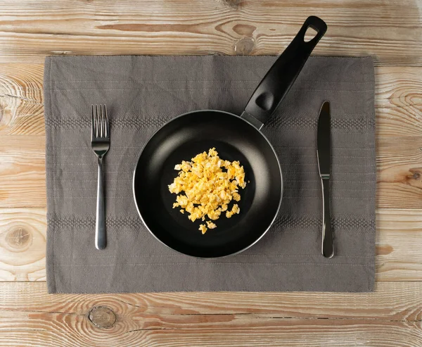 木製のテーブル上のビューにカトラリーとフライパンに卵やオムレツをスクランブルエッグ 素朴なキッチンモックアップともに朝ホットオムレツ 新鮮なオムレツ — ストック写真
