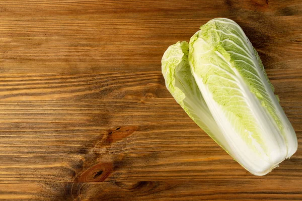 Cut Chinese Cabbage, Napa Cabbage or Wombok on Wooden Rustic Background with Copy Space. Fresh Green Cabbage Mockup Top View — Stock Image Cut Chinese Cabbage Napa Cabbage Wombok Wooden Rustic Background Copy Royalty Free Stock Photos