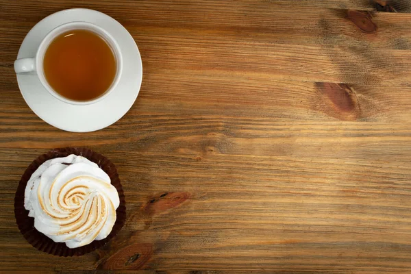 Big white meringue cookie mockup top view. Traditional homemade whisk merengues on wood background with copy space, baked whisking cream mock up or beze cooking recipe template