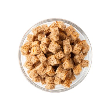 Pile of homemade rye bread croutons in wooden bowl isolated on white background top view. Crispy bread cubes, dry rye crumbs, rusks, crouoton or brown roasted crackers cube clipart