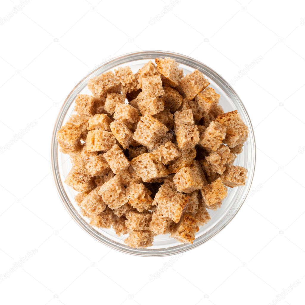 Pile of homemade rye bread croutons in wooden bowl isolated on white background top view. Crispy bread cubes, dry rye crumbs, rusks, crouoton or brown roasted crackers cube