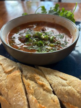 Bolca Vietnam usulü sığır güveci, Bo Kho, taze ekmek ve otlarla servis ediliyor. Bu aromatik yemek tabağında yemek ve yemek blogu fotoğrafçılığı için mükemmel bir çorba var.