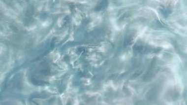 Mavi metalik gradyan, şampuan dokusuna benzeyen pürüzsüz soyut dalgalar, kozmetik sıvı veya ışıldayan pullar efektli duman bulutları.