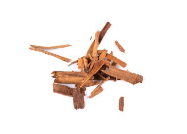 Broken ceylon cinnamon isolated, cinnamomum verum bark pieces, macro zeylanicum, real original cinnamon sticks, dry crumbled brown bark on white background close up
