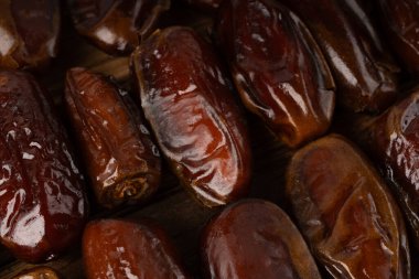 Macro close-up of a dry date pattern with selective focus. This healthy dried palm fruit textured background makes an ideal wallpaper for Ramadan food and Arabic sweets