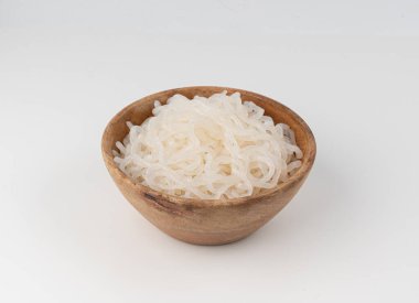 Shirataki veya konnyaku makarnası ahşap kasede izole edilmiş. Konjak jöleli erişte, Japon sıfır kalorili sirataki spagettisi, vegan cam vermicelli, geleneksel düşük kalorili yemek.