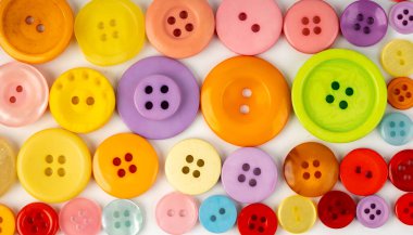 Renkli dikiş düğmeleri deseni. Beyaz arkaplan görünümünde kumaş, aksesuar desenli arka plan için farklı renk ve boyutlarda plastik dikiş düğmeleri