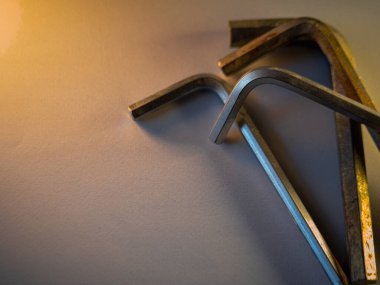 Metal uğursuz tuşlar serin gri bir yüzeyde durur. Sıcak ışık aletlerin etrafına yumuşak gölgeler bırakır. Her anahtar sıklıkla kullanıldığını gösteriyor. Araçlar gelişigüzel yalan söyler, tamir ya da montaja hazır olduğunu gösterir