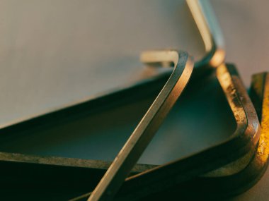 Metal aletler yumuşak, altın ışıkta durur. Hassas aletler sessiz kullanımla parıldıyor. İşçilik ve fonksiyon ince renklerle harmanlanır. Endüstriyel, onarım veya mekanik temalar için ideal