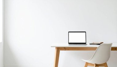 W 'ye karşı dizüstü bilgisayarı, sandalyesi ve defterleri olan minimalist çalışma alanı