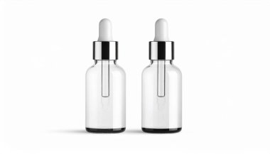 Beyaz damlalık kapaklı şeffaf cam şişeler. Beyaz arka planda serum ya da ilaç gibi sıvılar için kullanılıyor.