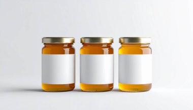 Three amber glass medicine bottles with gold caps and blank white labels on a plain white background