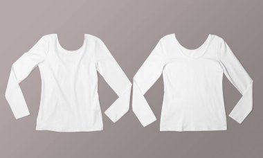 Moda ve giysi modeli için iki beyaz uzun kollu gömlek tarafsız bir zemine serilmişti.