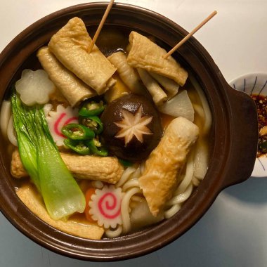A warm bowl of udon noodles in a savory broth, topped with fresh scallions and tempura. This Japanese comfort food offers a perfect blend of chewy noodles and umami-rich flavors!
