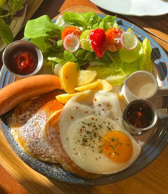 Fluffy souffles pancake topped with airy cream, sweet banana slices, and juicy peaches, offering a perfect blend of soft texture and fruity sweetness in every dreamy, melt in your mouth bite.