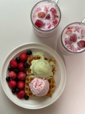 Crispy, golden waffles topped with creamy ice cream, creating a perfect balance of warm and cold, crunchy and smooth. A delightful dessert or breakfast treat, with toppings like fruits or syrup.