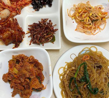 Warm and comforting jibbap (home-cooked Korean meal) with a spread of rice, soup, and banchan, offering a perfect harmony of flavor, tradition, and heartwarming nourishment in every bite.