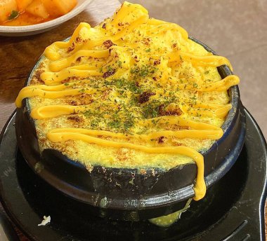 Steamed Korean egg dish, Gyeran Jjim, known for its light, fluffy texture. Served hot, often in an earthenware pot, this savory and comforting dish pairs well with rice and banchan.