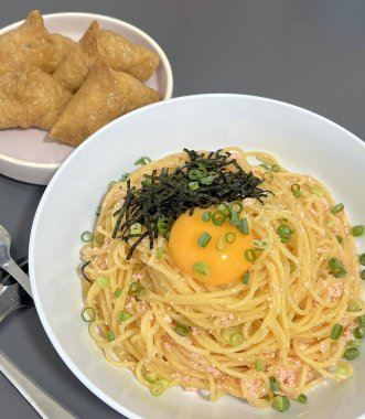 Creamy spaghetti carbonara made with rich egg yolk sauce, crispy bacon, parmesan cheese, and freshly ground black pepper for a classic, indulgent Italian pasta dish.