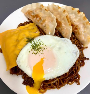 Savory jjapagetti with rich, black bean sauce and chewy noodles, paired with crispy, flavorful mandu. A delicious and satisfying Korean comfort food combination, perfect for any meal!