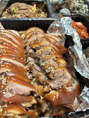 Jokbal, a Korean dish of braised pork hock, slow cooked in a rich, savory sauce with soy, garlic, and spices. Tender and flavorful, it's often served with lettuce wraps, garlic, and ssamjang