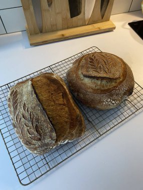 Sourdough bread with golden brown crust and rustic texture, sliced to reveal soft airy crumb inside, highlighting its natural shape, crisp surface, and artisanal detail in close-up view