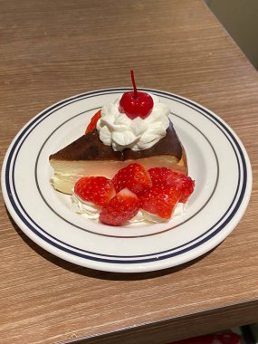 Soft and creamy cheesecake slice topped with juicy peach slices, blending rich, velvety texture with a sweet, fruity twist. A perfect balance of indulgence and freshness for a delightful dessert.