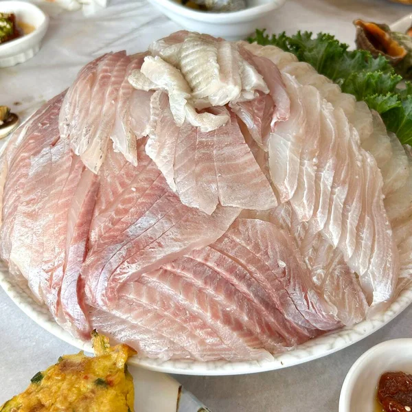 Taze ve narin gwang-eo hoe (yassı sashimi) temiz, yumuşak bir dokuya sahip, her zarif, ferahlatıcı ısırıkta ince bir tatlılık ve okyanus tazeliği mükemmel bir denge sunar.