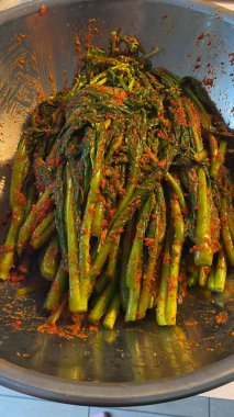 Pa kimchi, a flavorful Korean side dish made with scallions, fermented in a spicy, tangy seasoning. Perfect for enhancing meals, this vibrant dish captures the essence of traditional Korean cuisine.