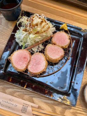 Çıtır tonkatsu, Japon usulü kızarmış domuz pirzolası dilimlenmiş lahana ve tuzlu sosla servis edilir. Lezzetli bir kıtır kıtır doku ve sulu et dengesi.