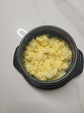 Steamed Korean egg dish, Gyeran Jjim, known for its light, fluffy texture. Served hot, often in an earthenware pot, this savory and comforting dish pairs well with rice and banchan.
