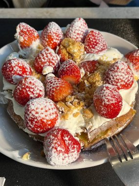 Crispy, golden waffles topped with creamy ice cream, creating a perfect balance of warm and cold, crunchy and smooth. A delightful dessert or breakfast treat, with toppings like fruits or syrup.