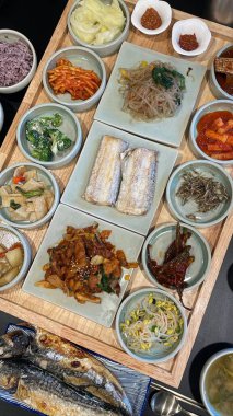 Warm and comforting jibbap (home-cooked Korean meal) with a spread of rice, soup, and banchan, offering a perfect harmony of flavor, tradition, and heartwarming nourishment in every bite.