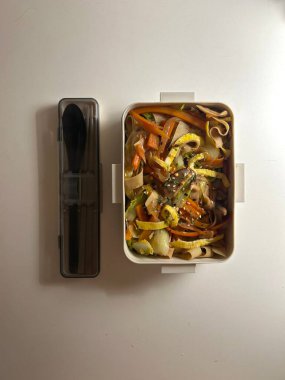 Bento or dosirak box filled with rice, assorted side dishes, vegetables, and protein like meat or fish, all neatly arranged to create a balanced, colorful, and visually appealing meal