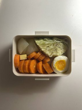 Bento or dosirak box filled with rice, assorted side dishes, vegetables, and protein like meat or fish, all neatly arranged to create a balanced, colorful, and visually appealing meal