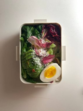 Bento or dosirak box filled with rice, assorted side dishes, vegetables, and protein like meat or fish, all neatly arranged to create a balanced, colorful, and visually appealing meal