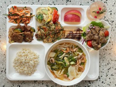 Masada kimçi, turşu sebze turşusu ve baharatlı sebzeler gibi çeşitli banchan (yan yemekler) içeren canlı bir Kore yemeği serpintisi. Yemek fotoğrafçılığı için mükemmel, geleneksel Korece sergileniyor..