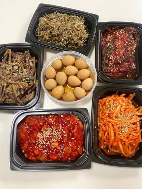 İçinde kimchi, baharatlı sebze, turp turşusu ve marine edilmiş yosun bulunan renkli bir banchan çeşidi. Bu Kore mezeleri masaya çeşitli dokular ve tatlar getiriyor..