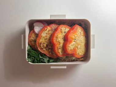 Bento or dosirak box filled with rice, assorted side dishes, vegetables, and protein like meat or fish, all neatly arranged to create a balanced, colorful, and visually appealing meal
