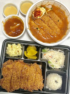 Bento or dosirak box filled with rice, assorted side dishes, vegetables, and protein like meat or fish, all neatly arranged to create a balanced, colorful, and visually appealing meal