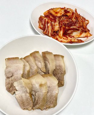 Yumuşak bir parça Bossam, Kore haşlanmış domuz göbeği, taze marul, sarımsak ve ssamjang ile servis edilir. Bu lezzetli ve lezzetli yemek geleneksel bir Kore yemeğini paketlemek ve paylaşmak için mükemmeldir..