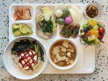 Masada kimçi, turşu sebze turşusu ve baharatlı sebzeler gibi çeşitli banchan (yan yemekler) içeren canlı bir Kore yemeği serpintisi. Yemek fotoğrafçılığı için mükemmel, geleneksel Korece sergileniyor..