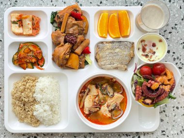 Masada kimçi, turşu sebze turşusu ve baharatlı sebzeler gibi çeşitli banchan (yan yemekler) içeren canlı bir Kore yemeği serpintisi. Yemek fotoğrafçılığı için mükemmel, geleneksel Korece sergileniyor..