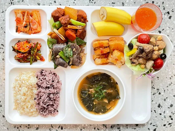 Masada kimçi, turşu sebze turşusu ve baharatlı sebzeler gibi çeşitli banchan (yan yemekler) içeren canlı bir Kore yemeği serpintisi. Yemek fotoğrafçılığı için mükemmel, geleneksel Korece sergileniyor..