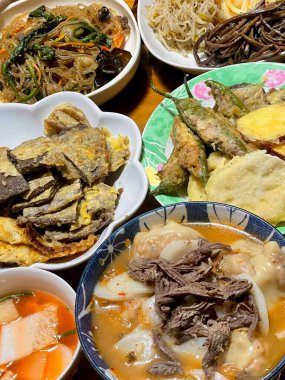 Warm and comforting jibbap (home-cooked Korean meal) with a spread of rice, soup, and banchan, offering a perfect harmony of flavor, tradition, and heartwarming nourishment in every bite.